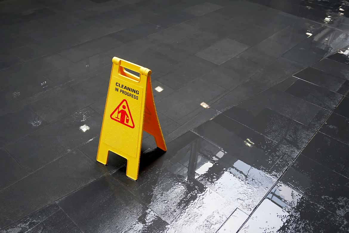 Clean floor with warning wet floor sign